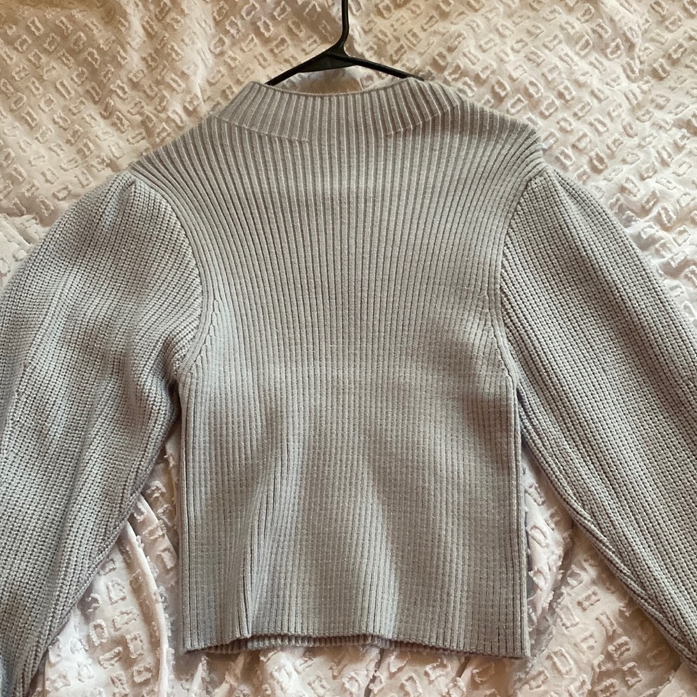 Truth, medium, light blue sweater